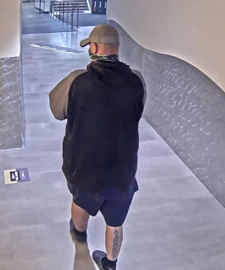 Image taken from surveillance video of the suspect from behind showing a tattoo on his right calf